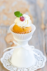 Cupcake with sugared berry and fresh mint leaf