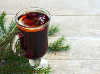 Winter background with glass of mulled wine