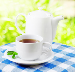 Cup of tea on nature background