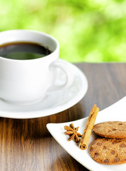 Coffee and oatmeal cookies on nature background