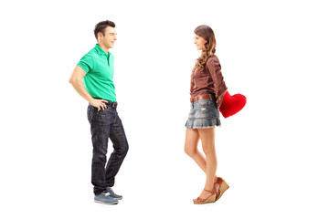 Obraz premium Male and female with red heart during a conversation