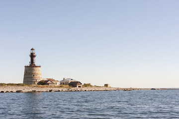 Fototapeta na wymiar Ancient lighthouse on an island