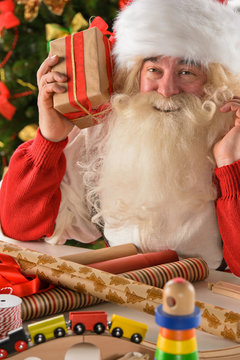 Santa Claus in his workshop making new toys