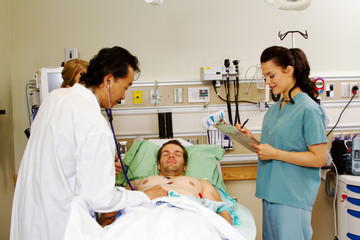 Fototapeta premium Doctor examing patient using stethoscope