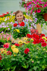 Garden center, girl holding flowers in garden center