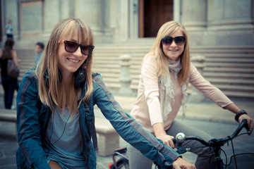 two beautiful blonde women shopping on bike