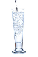 water pouring in a glass on white background.