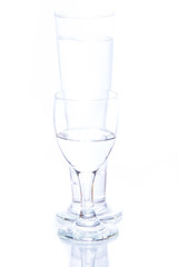 water pouring in a glass on white background.