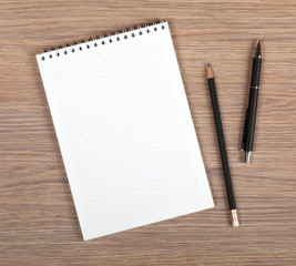 Blank notepad with pen and pencil