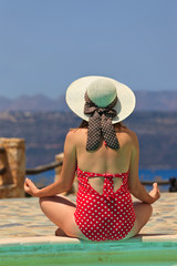 woman meditation near the pool