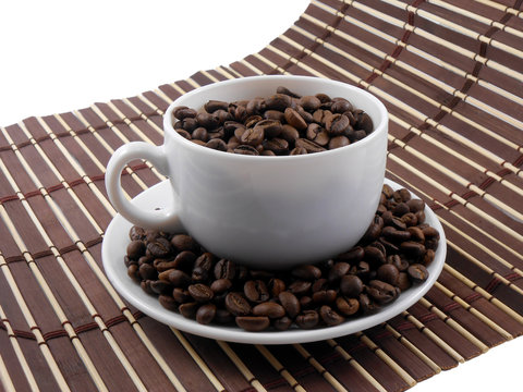 Coffee beans with coffee on bamboo background