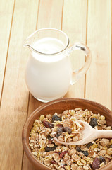 Plate with raw oatmeal on wooden table.