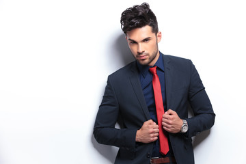 business man poses with hands on lapels