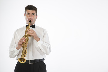 Fototapeta premium Young handsome man plays saxophone