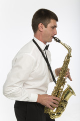Obraz na płótnie Canvas Handsome man plays saxophone