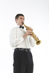Fototapeta premium Young handsome man plays saxophone