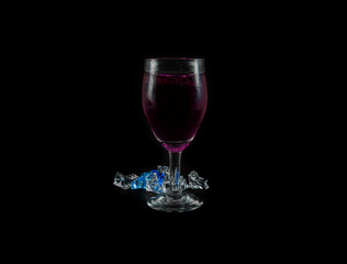 purple water drink in wine glass
