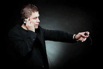 young man with headphones use mp3 music player