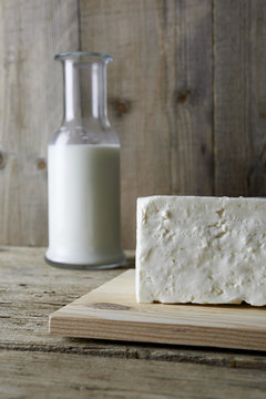 Fresh feta cheese with bottle of milk