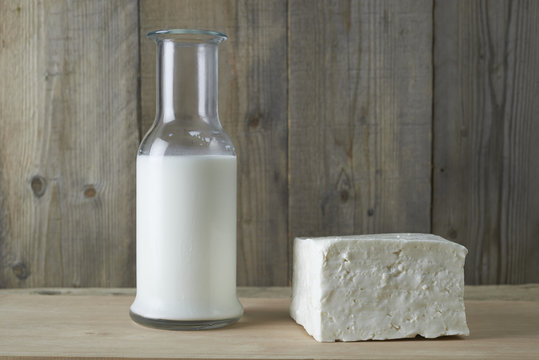 Fresh feta cheese with bottle of milk