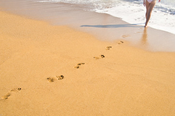 Woman's footprints on sand