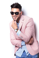 casual man laughing with hand on chin