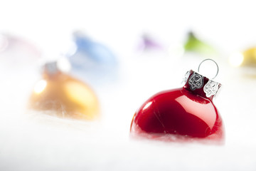 Red Christmas bauble in decorative snow