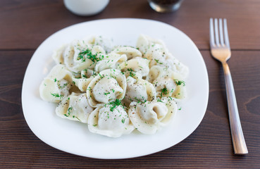 Fresh boiled meat dumplings served with dill
