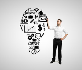 businessman drawing bulbs