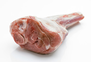 Crude whole veal shank, on white base