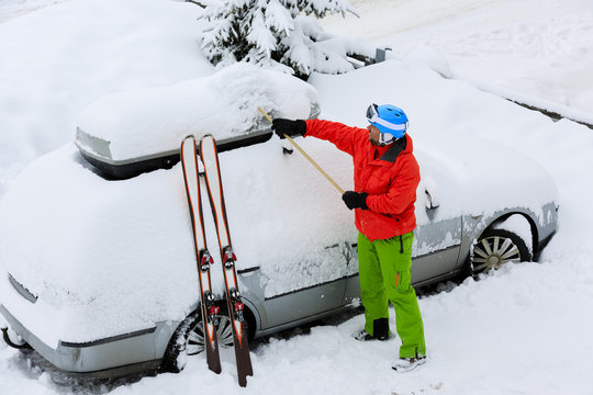 Skier Man Is Shoveling The Car Of Snow