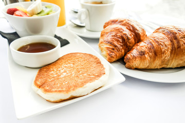 Breakfast with coffee and croissants