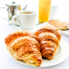 Breakfast with coffee and croissants