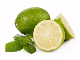 Fresh limes, mint leaves isolated on white