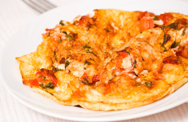 omelette with tomatoes, cheese and basil