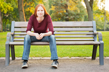 A Woman Waiting on a Bench in a Park
