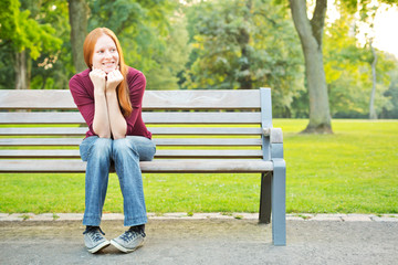 A Woman Waiting on a Bench in a Park