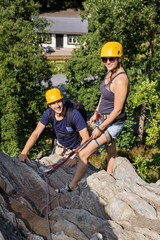 Climbers With Safety Equipment Relaxing On Rock