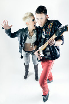 Young Couple With Rocker Outfit And Electric Guitar