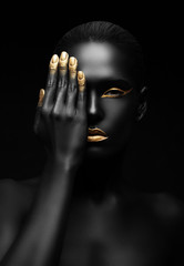 dark-skinned woman with golden make-up. - obrazy, fototapety, plakaty