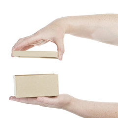 Hands opening cardboard box