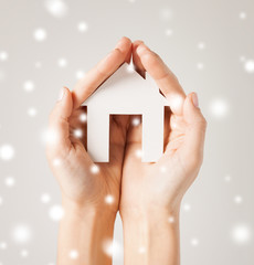 woman hands holding paper house