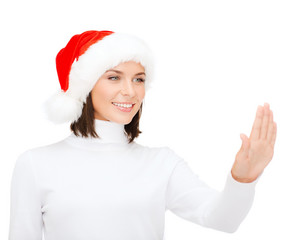 woman in santa helper hat pressing vitrual button