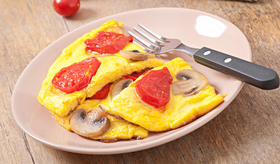 Delicious omelet with tomatoes and mushrooms for breakfast