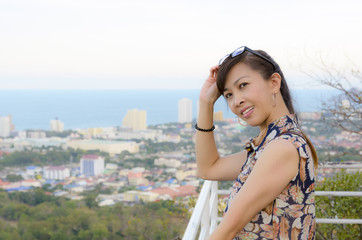 Woman poses on a high point overlooking the city.