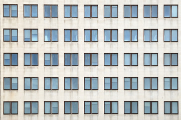 Multiple closed windows on a large office building - Powered by Adobe