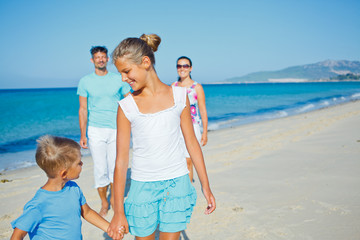 Fototapeta na wymiar family having fun on beach