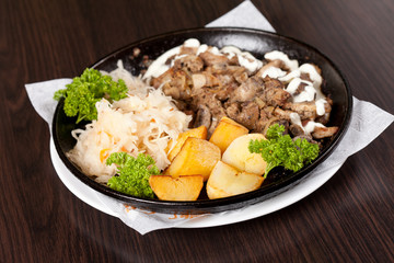 meat with potatoes in the pot