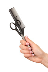 Color comb and scissors in female hand, isolated on white