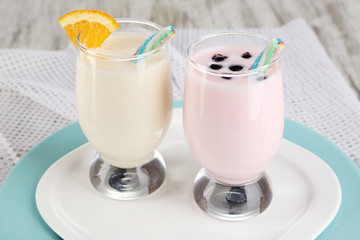 Delicious milk shakes with orange and blackberry